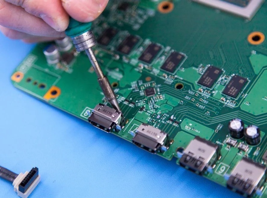 Technician micro-soldering PS5 HDMI port repair